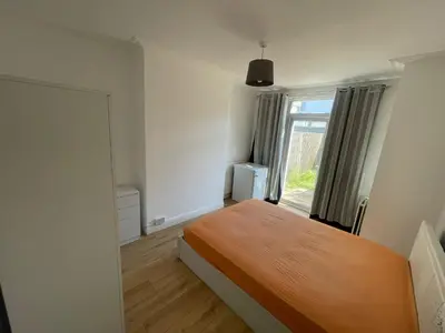 a small bedroom with a bed and a window at Large room with bathroom in Moffat