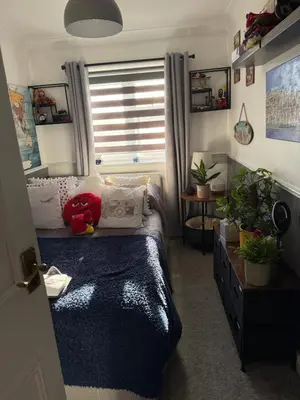 a bedroom with a bed and a window with plants at Traveler Nest in Moffat