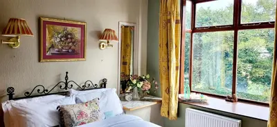 a bedroom with a bed and a window at Ash Lodge at The Barn in Gosforth
