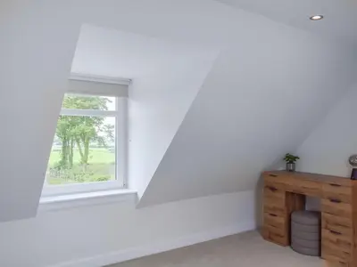 a white room with a window and a wooden dresser at High Wardneuk - Uk47041 in Symington