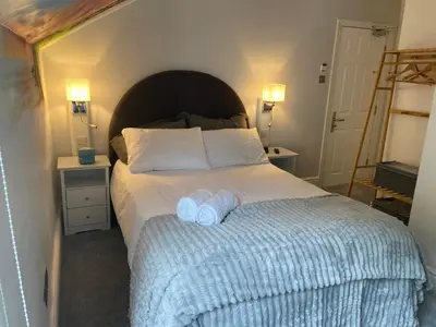 a bedroom with a bed with two towels on it at Serenity Suites in Douglas