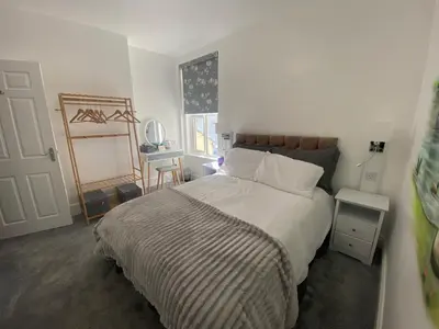 a bedroom with a large bed and a window at Serenity Suites in Douglas