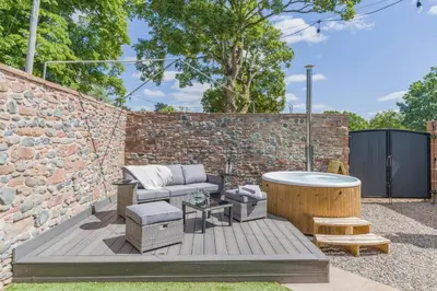 a backyard with a hot tub and a brick wall at 1 Bed in Dalston oc-s32206 in Dalston