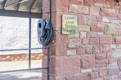 a green lane studio parking sign on a brick wall at 1 Bed in Dalston oc-s32206 in Dalston