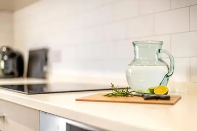 a glass jar on a counter with a cutting board with a lemon at 2 Bed in Dalston oc-g32205 in Dalston