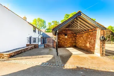 a brick building with a garage next to a white building at 2 Bed in Dalston oc-g32205 in Dalston