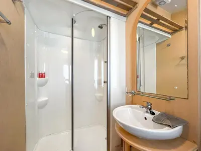 a bathroom with a sink and a shower at Keswick Reach in Cockermouth