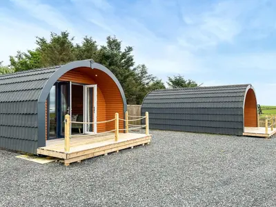 a circular building with a wooden porch in a parking lot at Keith - Uk49287 in Stranraer