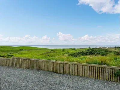 a fence on the side of a road near the ocean at Keith - Uk49287 in Stranraer