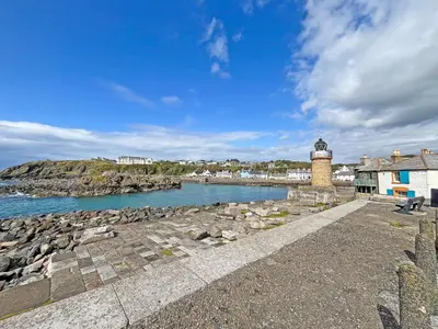 a lighthouse on the shore of a body of water at Keith - Uk49287 in Stranraer