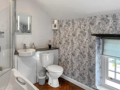 a bathroom with a toilet and a sink at Gillhead Farm Cottage in Troutbeck