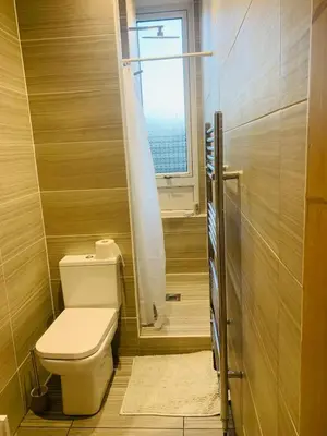 a small bathroom with a toilet and a window at Rachael's House in Moffat