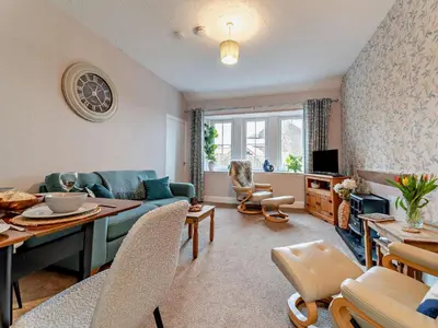 a living room with a couch and a table at 2 Bed in Maybole 96012 in Maybole