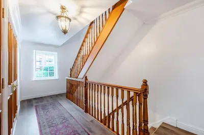 a staircase in a home with white walls and a chandelier at 5 Bed in St. Bees oc-w32446 in St Bees