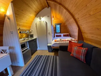 a small room with a bed and a kitchen at Queensland Holiday Park - Glamping in South West Scotland in Barrhill