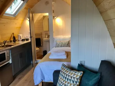 a small bedroom with a bed in a tiny house at Queensland Holiday Park - Glamping in South West Scotland in Barrhill