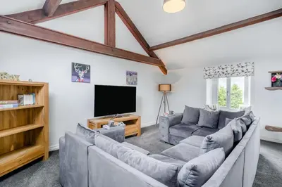 a living room with couches and a flat screen tv at 2 Bed in Troutbeck oc-b32579 in Troutbeck
