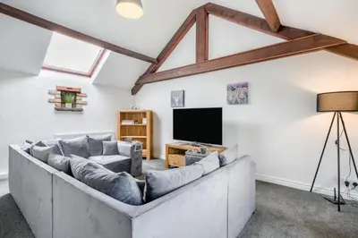a living room with a large couch and a flat screen tv at 2 Bed in Troutbeck oc-b32579 in Troutbeck