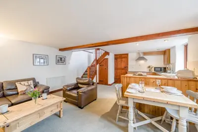a living room with a table and a kitchen at 1 Bed in Troutbeck oc-l32563 in Troutbeck