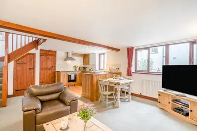 a living room with a couch and a tv and a kitchen at 1 Bed in Troutbeck oc-l32563 in Troutbeck
