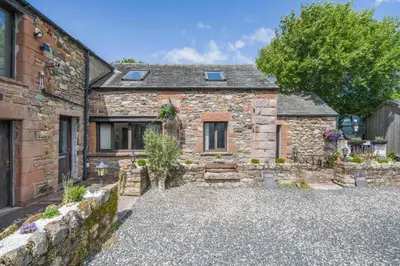 an old stone house with a gravel driveway at 1 Bed in Troutbeck oc-l32563 in Troutbeck