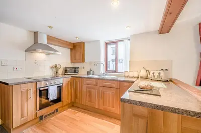 a kitchen with wooden cabinets and a counter top at 1 Bed in Troutbeck oc-l32563 in Troutbeck