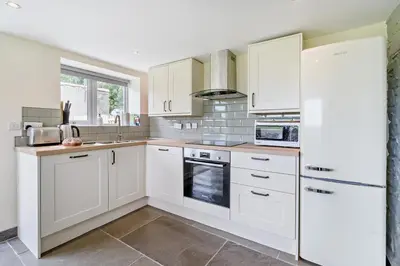 a white kitchen with white cabinets and appliances at 2 Bed in Ormathwaite oc-s32385 in Applethwaite