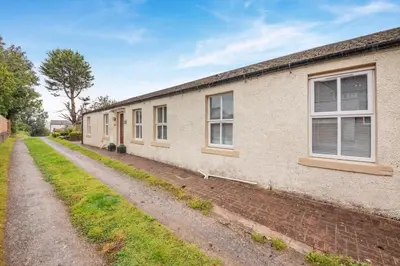 a row of houses on a dirt road at 2 Bed in Aspatria oc-p32645 in Aspatria