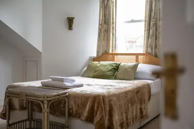 a bed in a room with a window at Elegant Town house in Edinburgh in Moffat