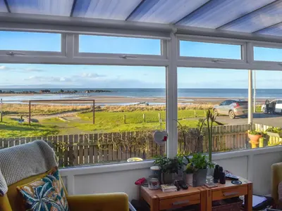 a living room with a view of the ocean at Bay View in Maidens