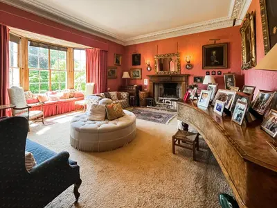 a living room with a couch and a fireplace at Amisfield Tower in Dumfries
