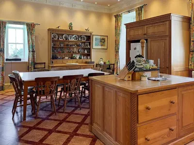 a kitchen with a table and a dining room at Amisfield Tower in Dumfries
