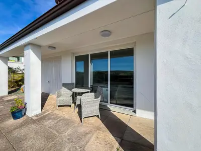a patio with chairs and a table on a balcony at Hydee House in Dumfries