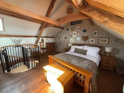 a bedroom with a large bed in a attic at Number 26 in Portpatrick