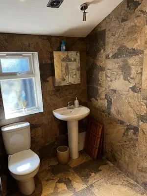 a bathroom with a toilet and a sink and a window at Number 26 in Portpatrick