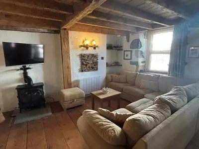 a living room with a couch and a tv at Number 26 in Portpatrick