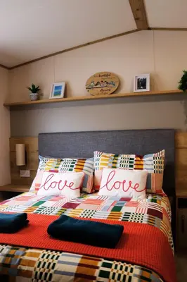 a bedroom with a bed with the words love on it at Relax, Enjoy fast Starlink Wi-Fi in Carlisle