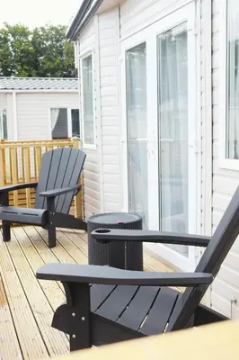 a pair of chairs and a table on a deck at Relax, Enjoy fast Starlink Wi-Fi in Carlisle