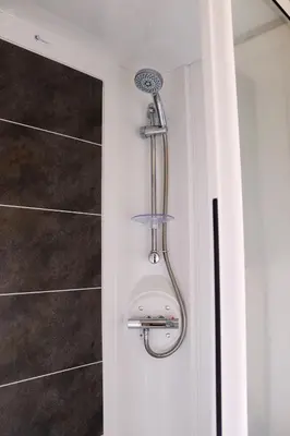 a shower in the corner of a bathroom at Relax, Enjoy fast Starlink Wi-Fi in Carlisle