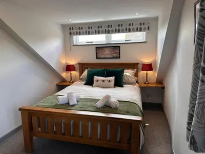 a bedroom with a bed with two towels on it at Charming cosy cottage near the Lake District in Penrith