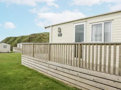a wooden fence in front of a house at Sandpiper in St Bees
