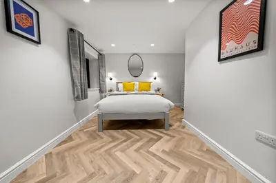 a bedroom with a bed in a room with white walls at The Salt Room Modern 1 Bedroom Home By AltoLuxo Short Lets Serviced Accommodation With Free Wifi & Parking in Moffat