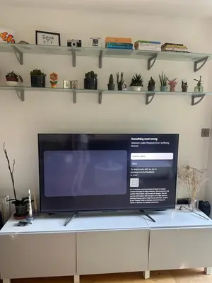 a flat screen tv sitting on top of a cabinet at Central London in Moffat
