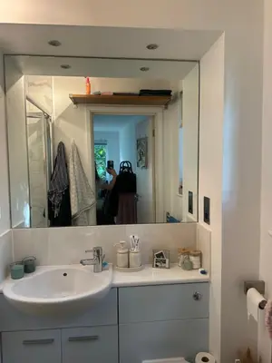 a bathroom with a sink and a mirror at Central London in Moffat