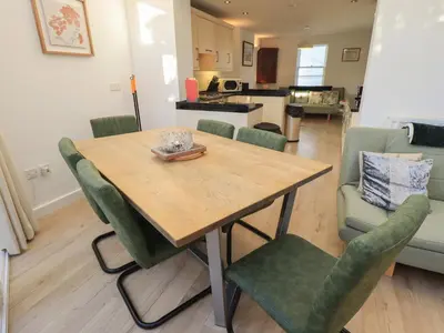 a kitchen and dining room with a wooden table and chairs at Swirl Howe in Keswick