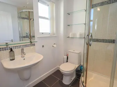 a bathroom with a toilet and a sink and a shower at Swirl Howe in Keswick