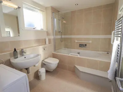 a bathroom with a sink and a toilet and a bath tub at Swirl Howe in Keswick