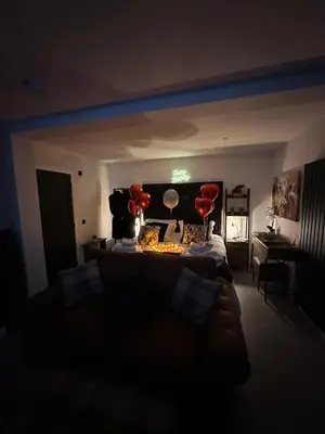 a living room with a couch and two red balloons at Hamish's Hideaway in Eaglesfield