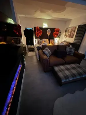 a living room with a couch and a tv at Hamish's Hideaway in Eaglesfield