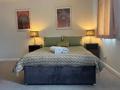 a bedroom with a bed with two towels on it at Stay Still Indian Court in Dalston